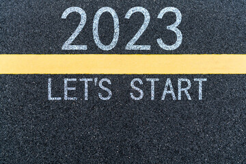 Fototapeta premium Number 2023 and yellow line on asphalt road