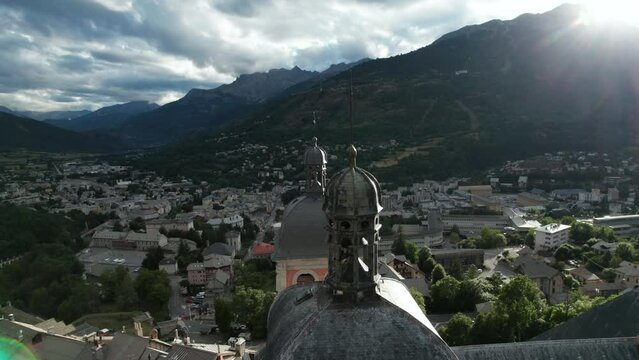 Nice old village with old church at bottom of forested hill, near the church top. Aerial shot of Briancon, one of France historical towns