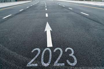 Number 2023 and arrow symbol on asphalt road