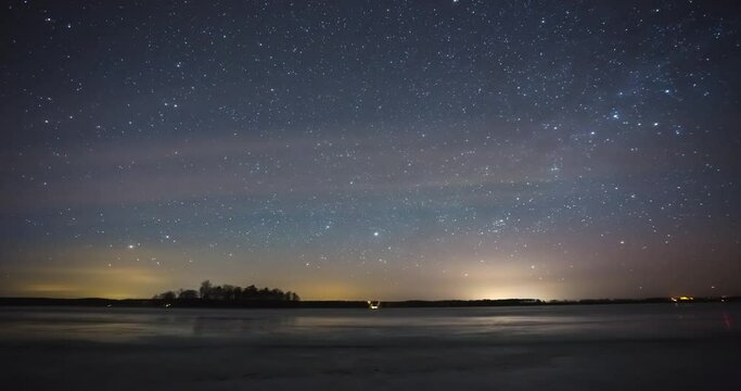 Timelapse of night sky with stars, milky way over the frozen lake with reflection, 4k time-lapse video