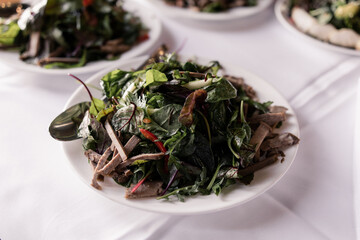 salad with meat in a plate on the table