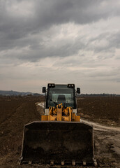 Fototapeta premium bulldozer on construction site, cloudy day, no driver