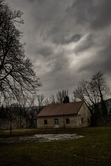 ground floor stone building in solitude, early spring, cloudy skies