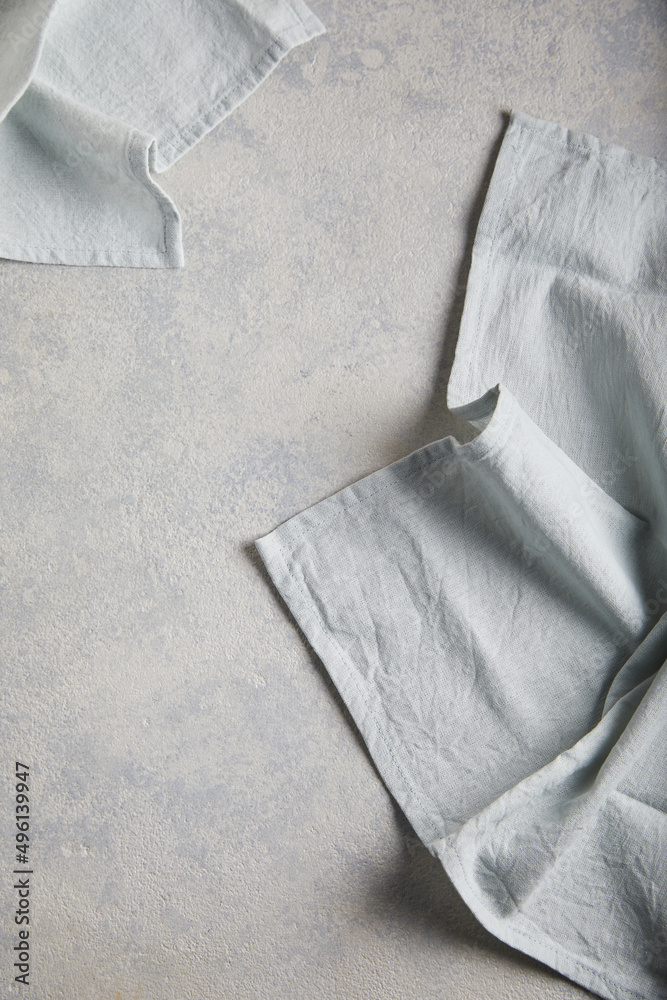 Wall mural light linen napkin on gray concrete texture or background. with place for text and image