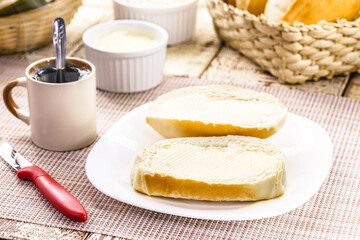Fototapeta na wymiar slice of salt bread cut with butter, called French bread in Brazil, Brazilian breakfast