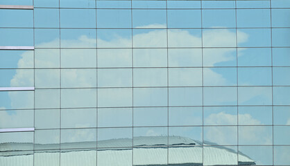 Clouds reflected in Blue windows of modern office building