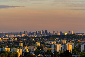 Fototapeta na wymiar Panorama of La Defense Business District at Golden Hour With Trees and Hill