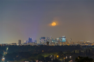 Full Moonrise Over La Defense Business District at Night Buildings and Trees