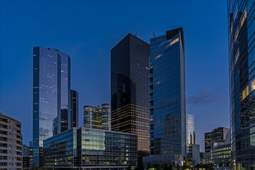 Fototapeta na wymiar Twilight Sunset Over La Defense District Skyline With Towers and Reflections