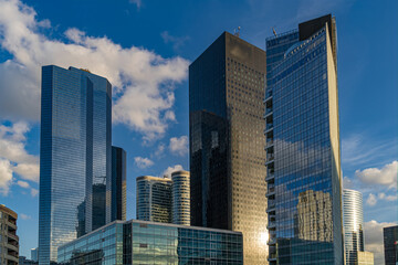 Fototapeta na wymiar La Defense Business District Covered by Cloudy and Sunny Sky Reflections