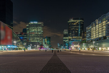 Fototapeta na wymiar Peoples at La Defense Business District Center at Night With High Towers