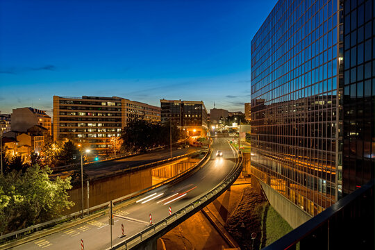 Road Traffic Moving Alongside Buildings at La Defense Business District at Blue Hour