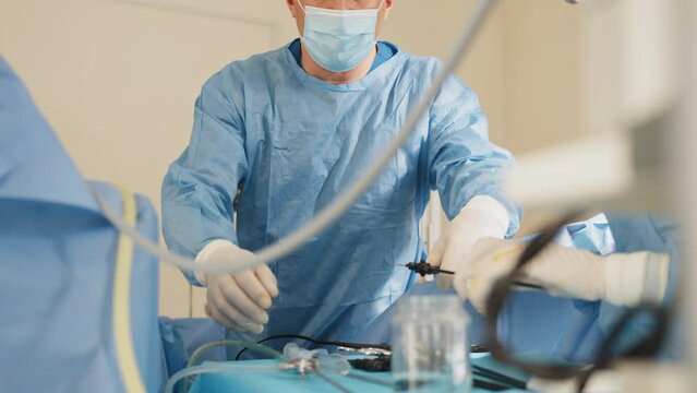 Endoscopic transnasal surgery. The operation was conducted Professor and assistant .Laparoscopic scissors and graspers on blue desk. Multifunction Laparoscopic Instruments