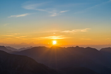 Fototapeta premium Intense Sunrise Over French Alps Mountains Peaks With Clouds