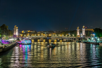 Fototapeta premium Paris Center at Night with Boats Traffic Over Seine River Bridges and Docks