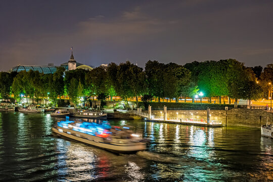Seine River and Boats Cruises in Paris at Night With Docks and Trees