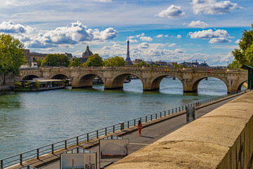 Fototapeta na wymiar Cloudy Sky Over Paris Touristic Center With Seine River at Summer Day