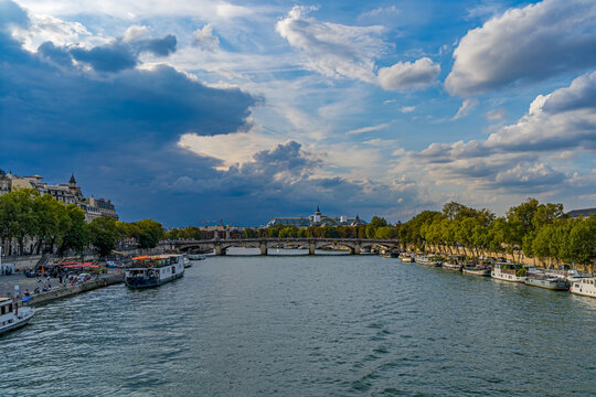 Storm Arriving Over Paris Center Seine River and Bridges Boats and Traffic Clouds