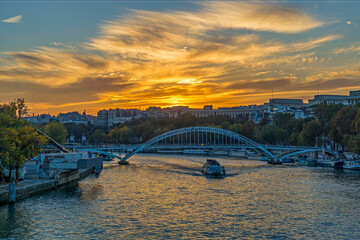 Colorful Clouds During Sunset Over Paris Seine River and Boats Cruises