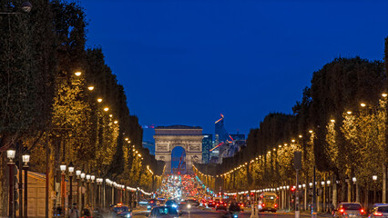 Champs-Elysees Avenue in Paris at Night With La Defense Business District in Background - obrazy, fototapety, plakaty