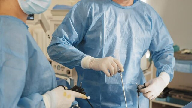 The operation was conducted Professor and assistant. Endoscopic transnasal surgery. .Laparoscopic scissors and graspers on blue desk. Multifunction Laparoscopic Instruments
