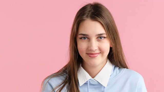 School girl witn blonde long hair showing different facial expression, from serios to happy emotion.