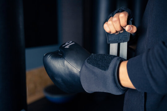 Crop sportsman fastening boxing glove