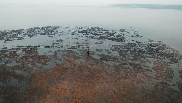 AERIAL: Wide circle of Whiteford Lighthouse at low tide, Whiteford, 4k Drone
