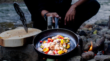 Bushcraft cooking grilled chicken salad. bushcraft and wild cooking concept.