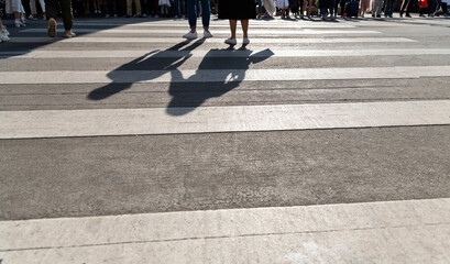 Shadows of people on the crosswalk