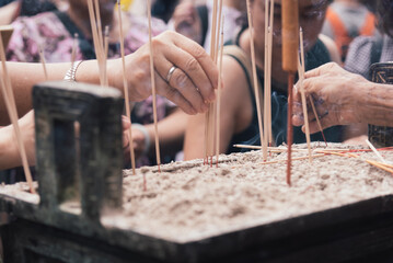 People visit temples to offer joss sticks to gods and Buddhas, worship and pray for good fortune on tradional festival in china. Traditional Chinese folk customs.