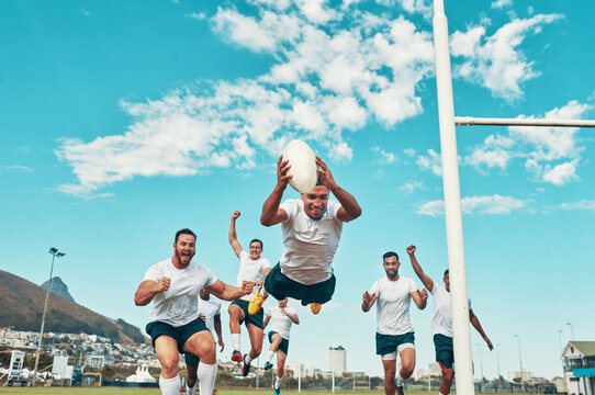 Hes the man of the match. Shot of a rugby player scoring a try while playing on a field.
