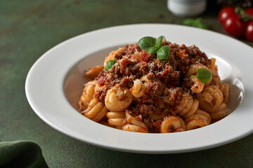 pasta bolognese on a dark green background