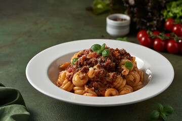 pasta bolognese on a dark green background