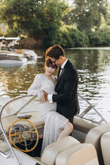 Happy bride and groom on a yacht traveling together on a warm summer day