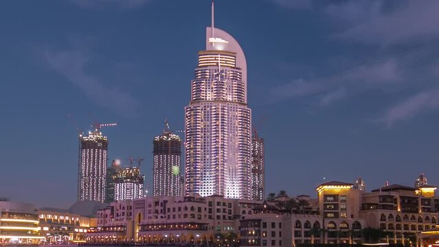 The Dancing Fountain of Dubai and lake day to night timelapse at dusk in Dubai, UAE.
