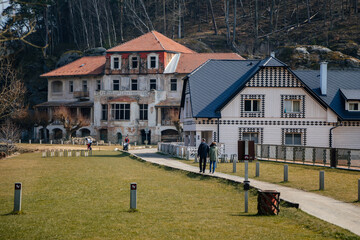 Fototapeta na wymiar Vysoka Bosyne, Czech Republic, 19 March 2022: Former hotel and house of Harabistro, formation and protected landscape area in Kokorinsko, sandstone cliffs, lake Harasov at sunny day, rocks and hills
