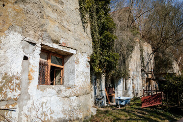 Truskavna Czech Republic, 19 March 2022: Rock apartment, abandoned house, broken open window, old bathroom, formation and protected landscape area in Kokorinsko, sandstone cliffs at sunny day