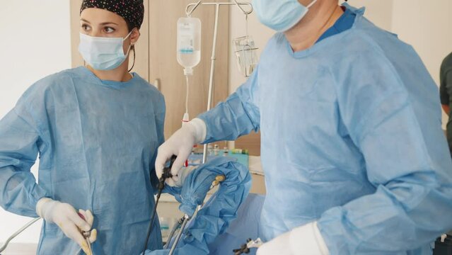 Minimally invasive surgery. Female surgeon perform a delicate operation. Modern medicine in hospital. Surgical intervention in abdominal cavity for treatment or elimination of pathology.