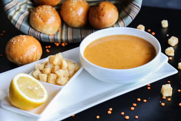 lentil soup, delicious lentil cream-soup with lemon and small pieces of twice-baked bread, rusk