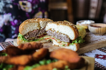 eating tasty grilled prawn and beef burger