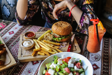 eating tasty grilled prawn and beef burger
