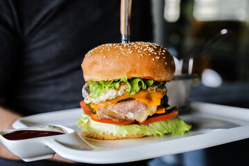 eating tasty grilled prawn and beef burger
