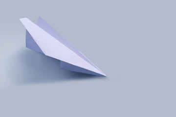 Paper airplane on a tone-harmonious background, toned