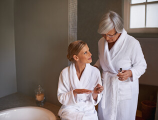 Getting the bride ready for her big day. Shot of a young woman painting her nails while her...