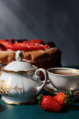 Colorful still life with Birthday cake and retro styled tableware. Strawberry cake on a table. 