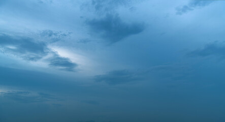 Naklejka na ściany i meble Gray clouds in dark blue sky