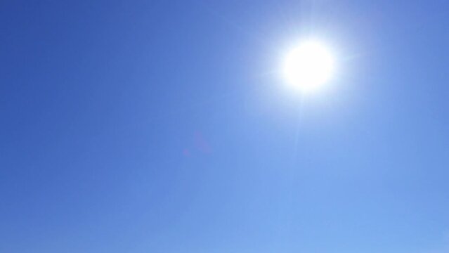 4k tropical summer sun light ray on sunny clear blue sky TimeLapse