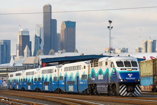 Seattle - March 29, 2022; Southbound Sounder evening commuter train leaving Seattle with the skyline behind