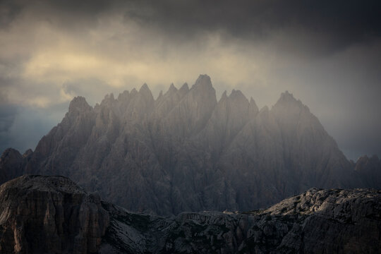Haunold mountain chain with storm clouds during sunset at Three Peaks Hut in the Dolomite Alps in South Tyrol, Italy.